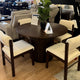 Round dining table with cream chairs at Palacio Furniture